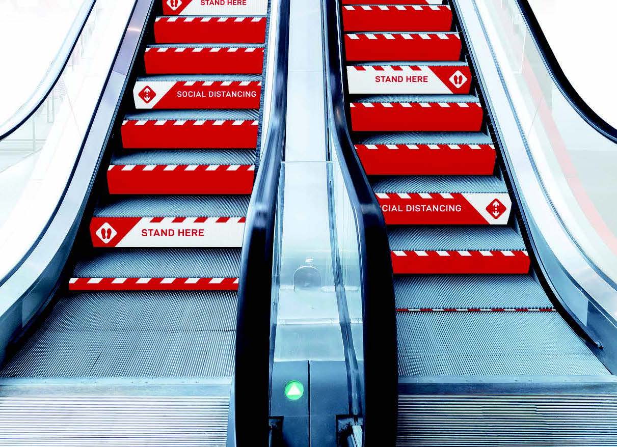 Social distancing step markers on an escalator